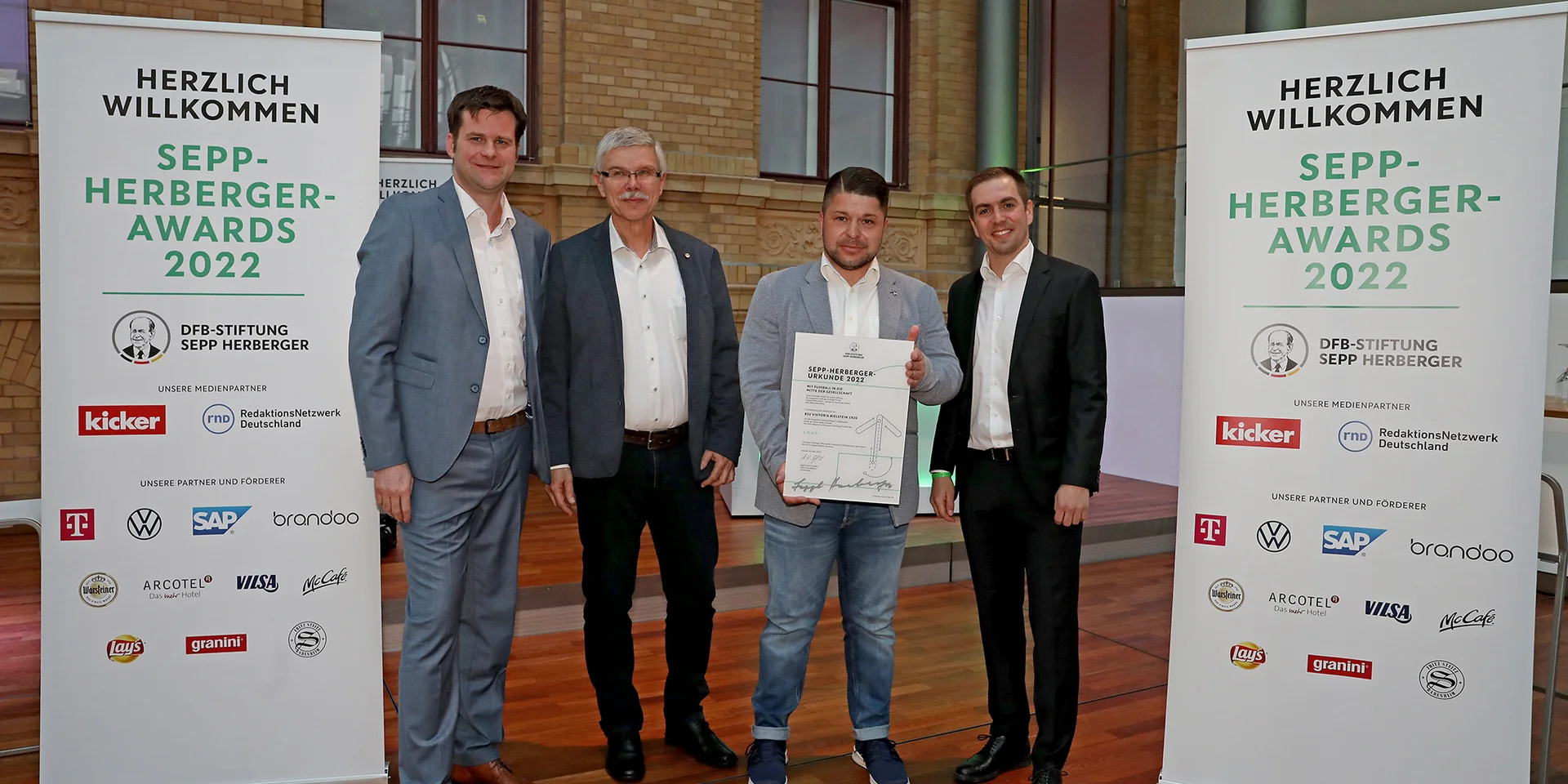 Christof Fries und Christopher Pethe nahmen den Sepp-Herberger-Preis 2022 in Silber aus den Händen von DFB-Vizepräsident Ralph-Uwe Schaffert und Ex-Fußballprofi Philipp Lahm entgegen (Foto: Carsten Kobow/DFB-Stiftung Sepp Herberger)